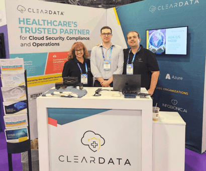 ClearDATA team at HLTH 2025 discussing cloud security for healthcare and compliance solutions, with booth signage highlighting multi-cloud and HIPAA-compliant managed services.
